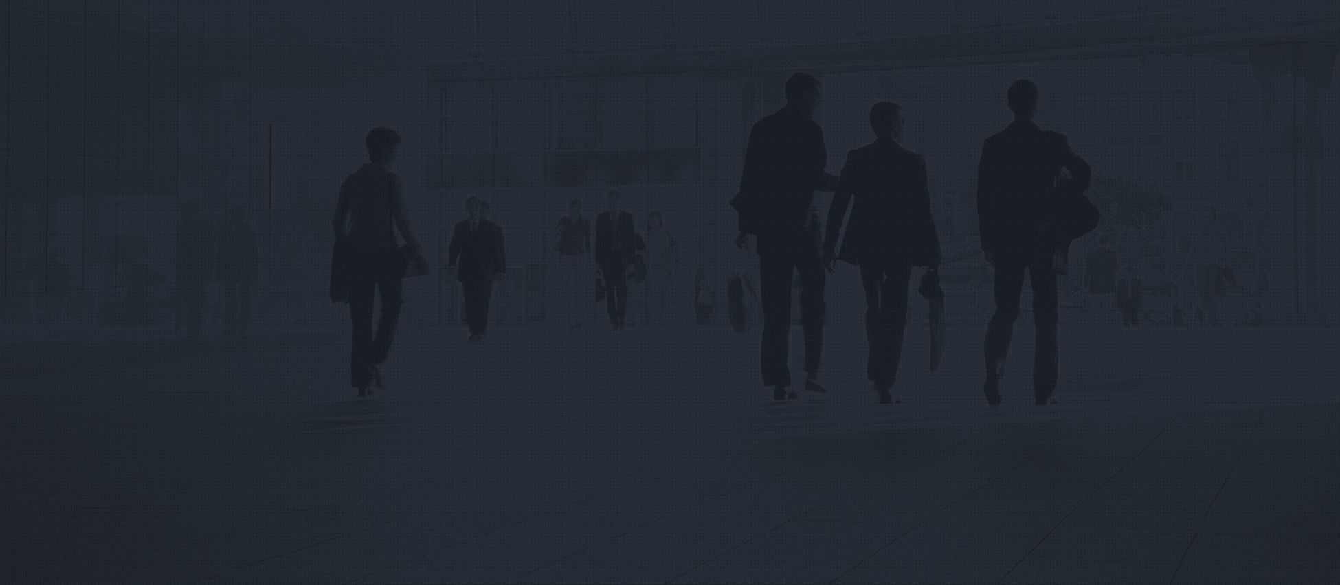 Silhouettes of business people walking in an office building lobby.